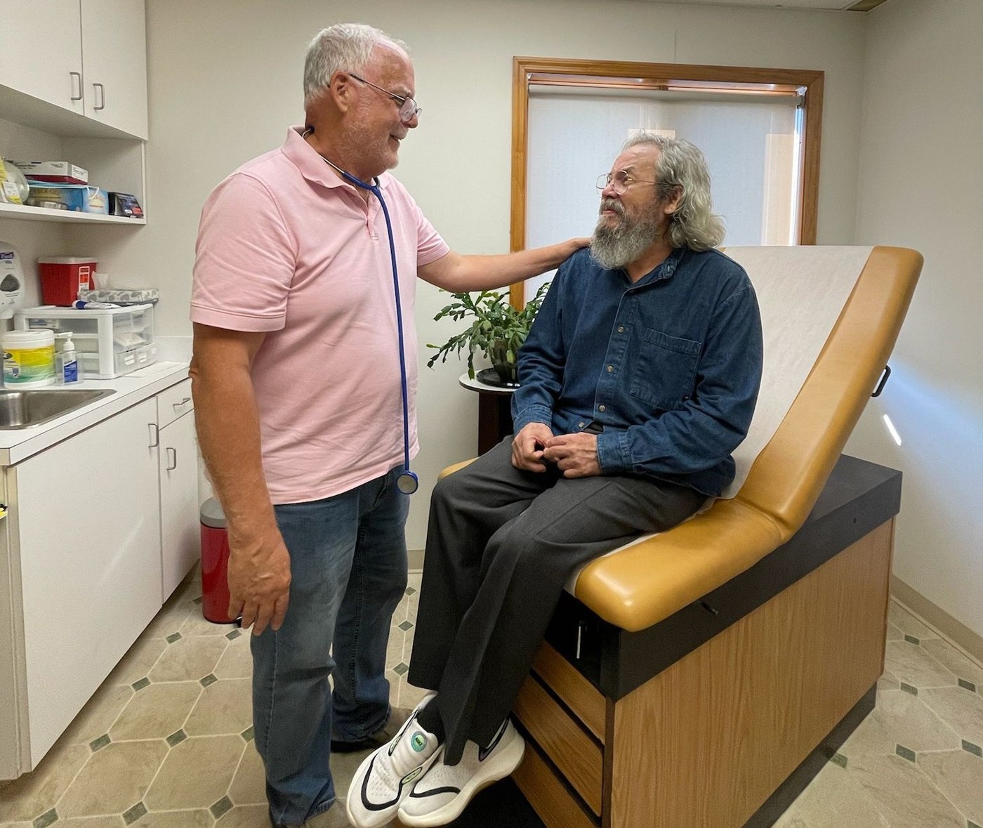 A physician talking with a patient at the Oneonta clinic
